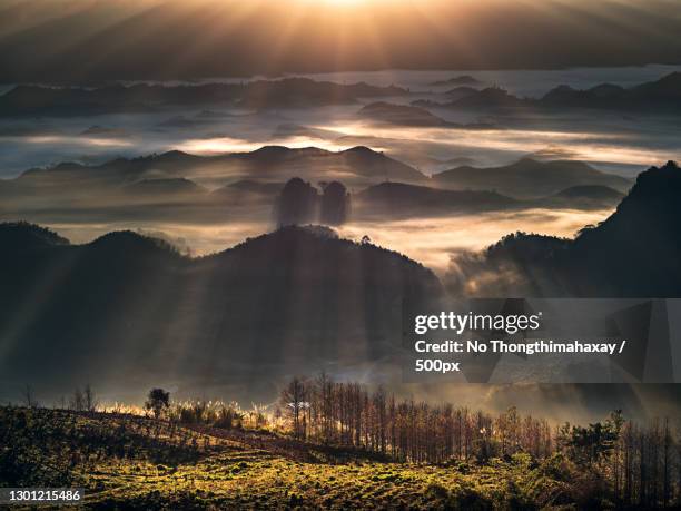 scenic view of landscape against sky during sunset,laos - laos foto e immagini stock