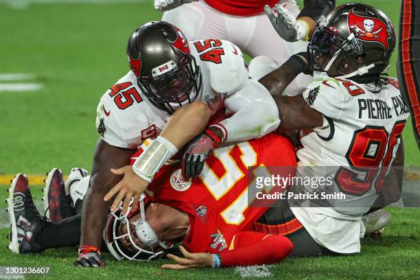 Patrick Mahomes of the Kansas City Chiefs is tackled by Jason Pierre-Paul and Devin White of the Tampa Bay Buccaneers in the fourth quarter during...