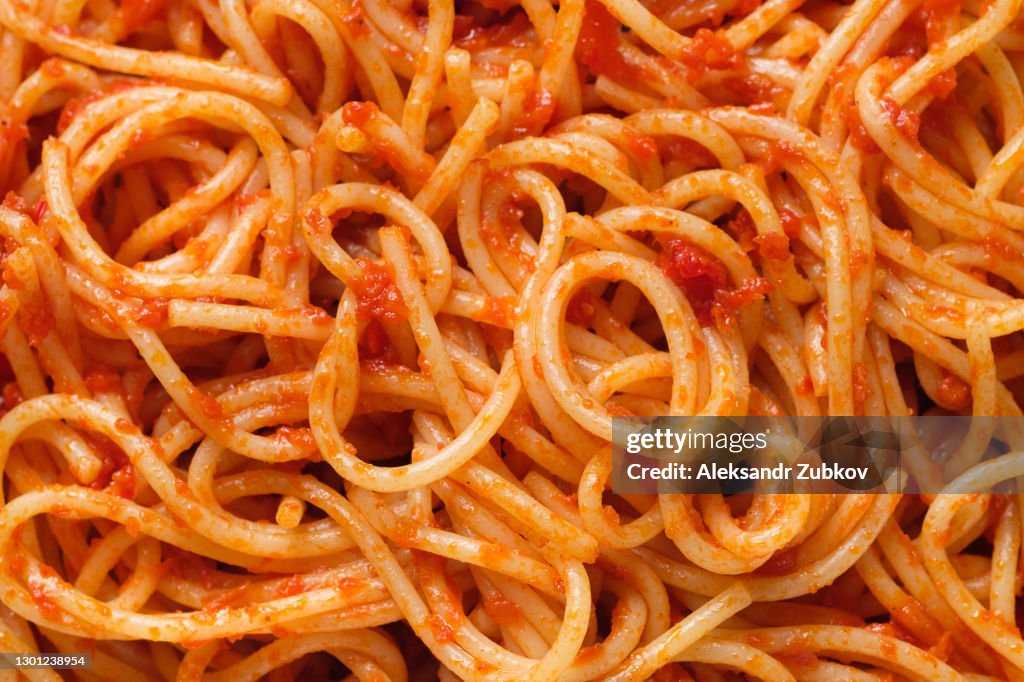 Spaghetti or pasta bolognese in tomato sauce on a ceramic plate, on a white background or table. The concept of Vegetarian and Vegan Food. Food background.
