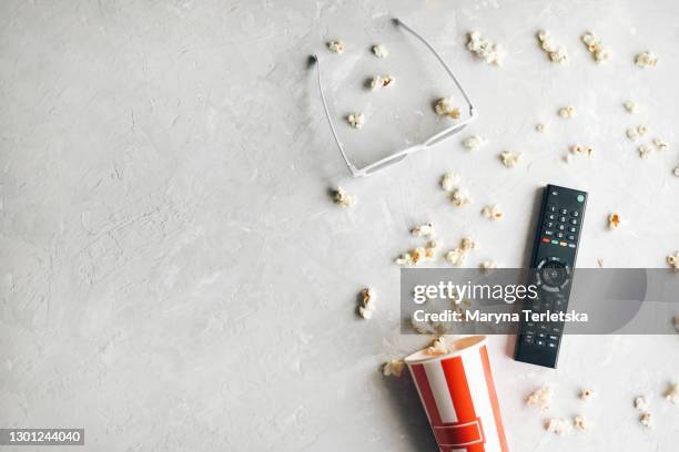 background with popcorn, remote control and 3d glasses. - movie and tv awards show stock pictures, royalty-free photos & images