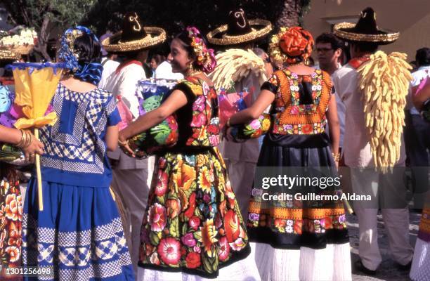 View of a group of colorfully dressed Tehuana woman as they prepare for the annual Zapotec Best Dressed show, Juchitan, Veracruz, Mexico, 1985.