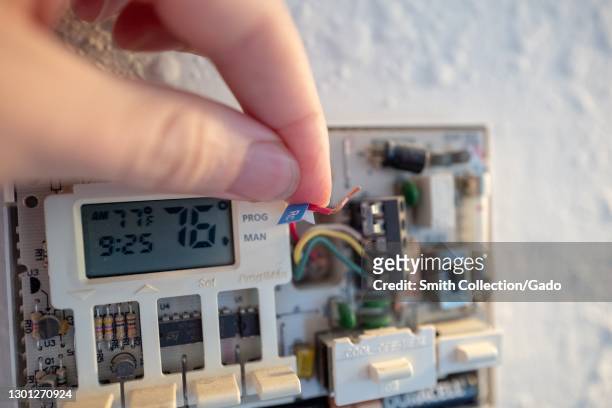 Attachment of coded wires during installation of Google Nest Learning Thermostat during a smart home renovation project in Lafayette, California,...
