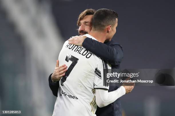 Andrea Pirlo Head coach of Juventus embraces Cristiano Ronaldo of Juventus following the final whistle in the Coppa Italia semi-final between...