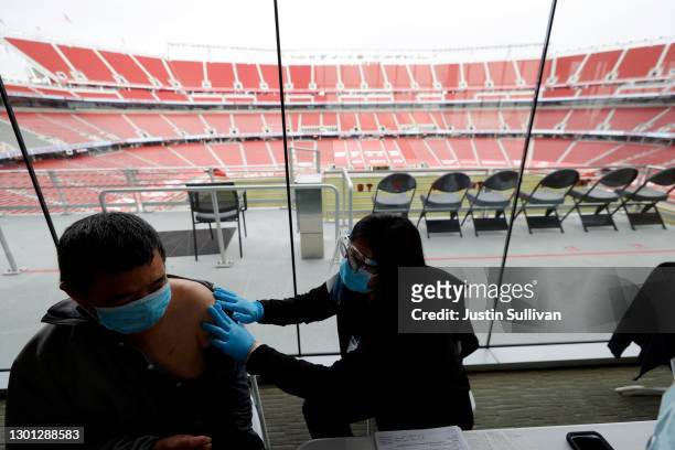 Xiangheng Liu of San Jose prepares to receive a COVID-19 vaccination on the opening day of a mass COVID-19 vaccination site at Levi's Stadium on...