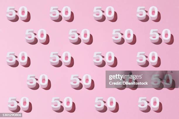 white pattern 50 on pink background. golden anniversary concept - 50th anniversary background stock pictures, royalty-free photos & images