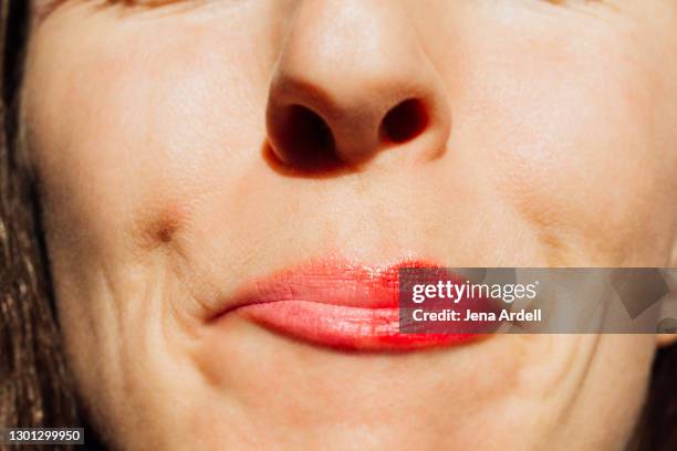 pink lipstick vs. red lipstick: choosing makeup and indecision - extreme close up kiss stock pictures, royalty-free photos & images