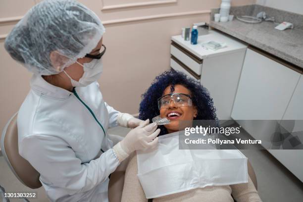 dentist testing dental mold on patient - baby bib stock pictures, royalty-free photos & images