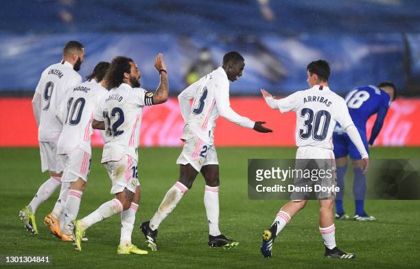 Ferland Mendy of Real Madrid celebrates with Sergio Arribas and Marcelo after scoring his team's 2nd goal during the La Liga Santander match between...