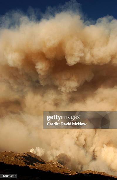 An enormous column of smoke rises from upper Borrego Palm Canyon in the Anza-Borrego Desert State Park near the boundary of the Los Coyotes Indian...