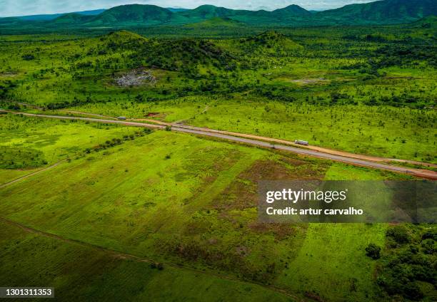 endless road in the african landscape - angola drone stock pictures, royalty-free photos & images