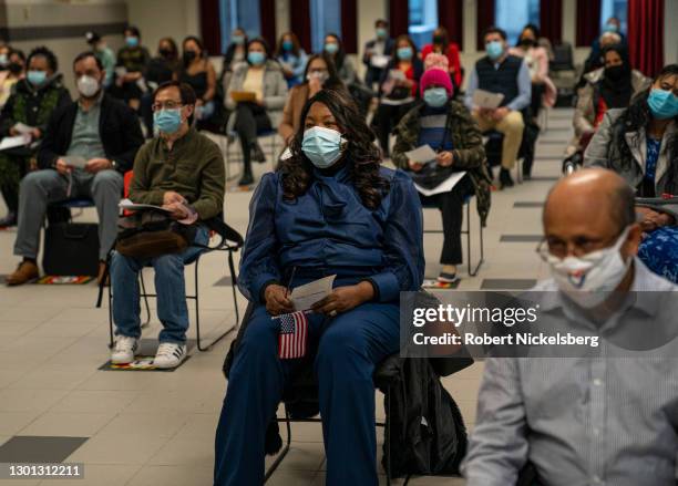 Candidates for U.S. Citizenship listen to the presiding field officer during a naturalization ceremony February 9, 2021 in the Manhattan borough of...