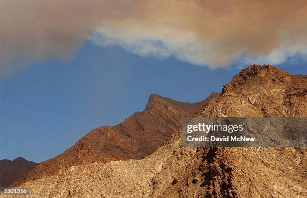 Smoke shadows Indianhead Mountain in the heart of rare and endangered peninsular desert bighorn sheep habitat as wildfire threatens to reach the...