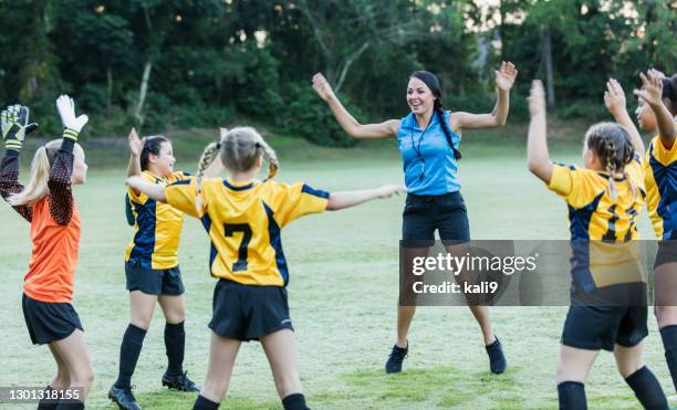 girls soccer coach leading team warm up - jumping jack stock pictures, royalty-free photos & images