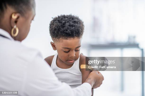 getting vaccinated - african american band aids stock pictures, royalty-free photos & images