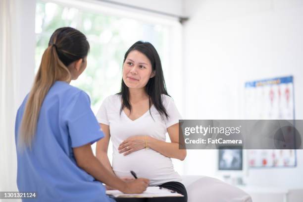 pregnant woman goes for medical check-up - obstetrics stock pictures, royalty-free photos & images