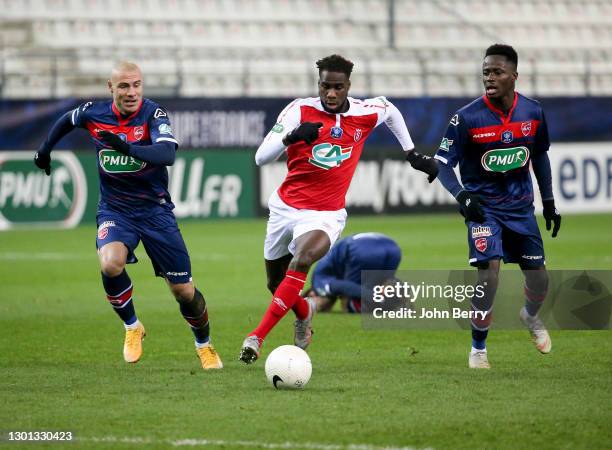 Boulaye Dia of Reims between Jaba Kankava and Emmanuel Ntim of Valenciennes during the French Cup match between Stade Reims and Valenciennes FC at...