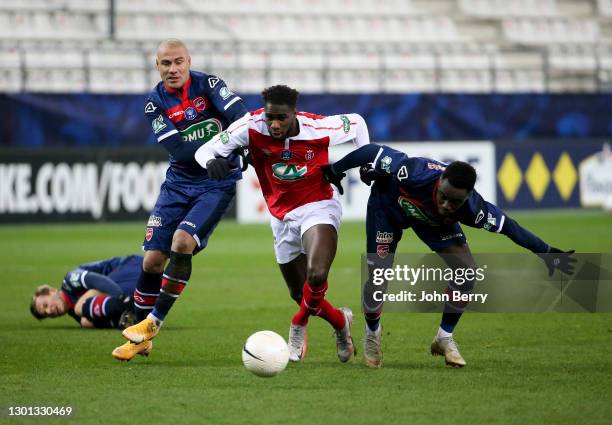 Boulaye Dia of Reims between Jaba Kankava and Emmanuel Ntim of Valenciennes during the French Cup match between Stade Reims and Valenciennes FC at...