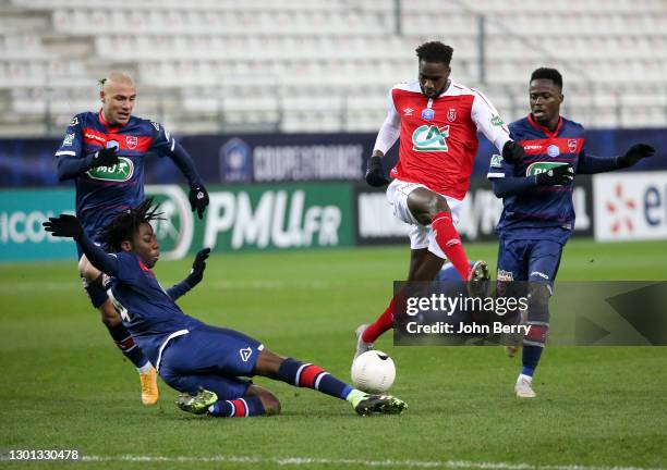 Boulaye Dia of Reims between Ismael Doukoure, Jaba Kankava and Emmanuel Ntim of Valenciennes during the French Cup match between Stade Reims and...