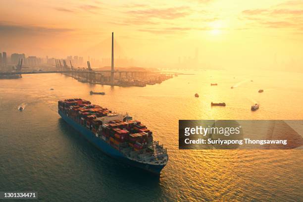 aerial view container cargo ship full carrier container at terminal commercial port transporting shipment container for business logistics, import export, shipping or freight transportation. - business finance and industry stock pictures, royalty-free photos & images