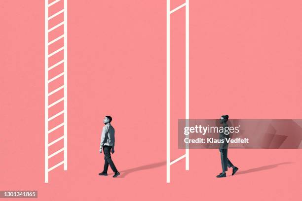 young man and woman walking towards white ladders - female equality stock pictures, royalty-free photos & images