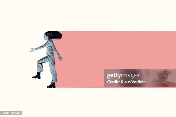 woman with tousled hair leaving coral trail - initiative stock pictures, royalty-free photos & images