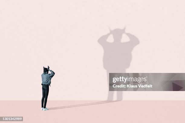 young woman making devil shadow - panic stock pictures, royalty-free photos & images