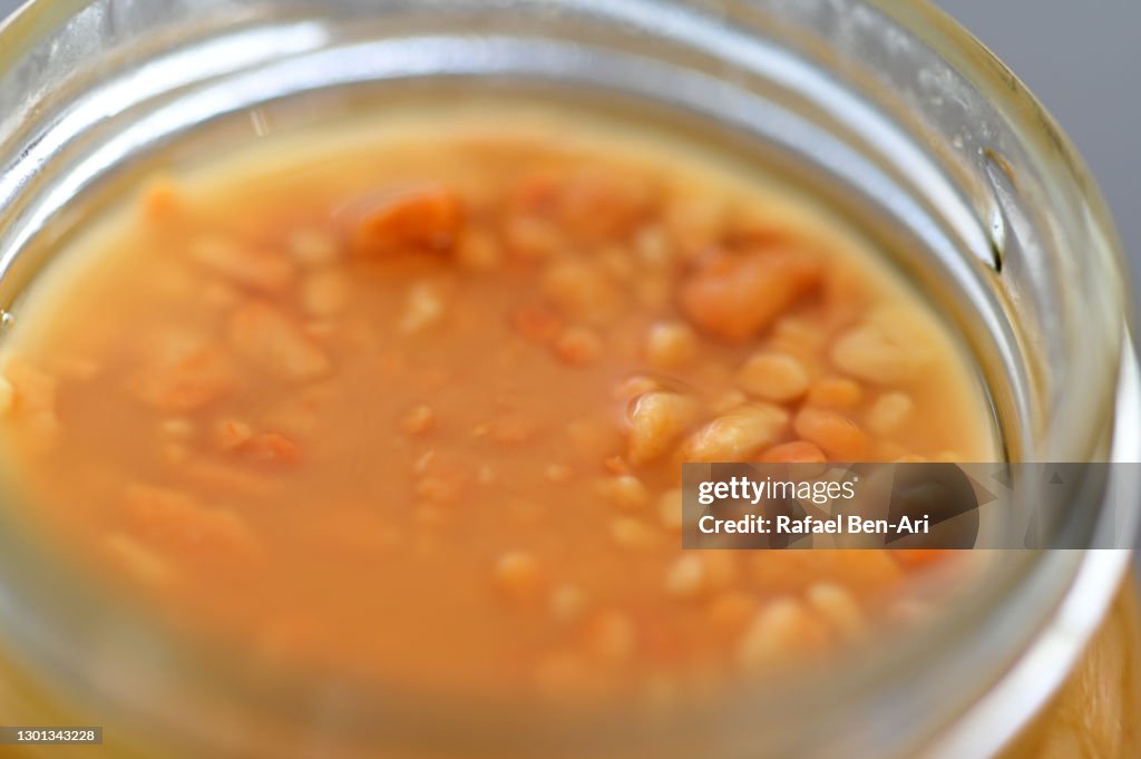 Crunchy peanut butter spread in a glass jar