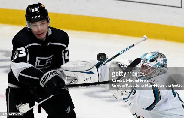 Los Angeles, CA Goalie Martin Jones of the San Jose Sharks eyes a shot as Dustin Brown of the Los Angeles Kings looks on during the second period of...