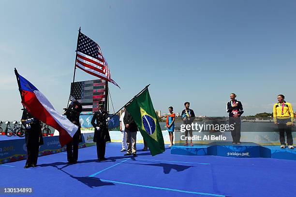 Sarah Haskins of the USA, Barbara Riveros of Chile, and Pamella Nascimento of Brazil stand at the podium at the medal ceremony for theTriathlon at...