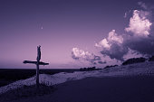 Purple landscape with wooden Cross or crucifix.  Concept for Lent Season, Holy Week, Palm Sunday and Good Friday.