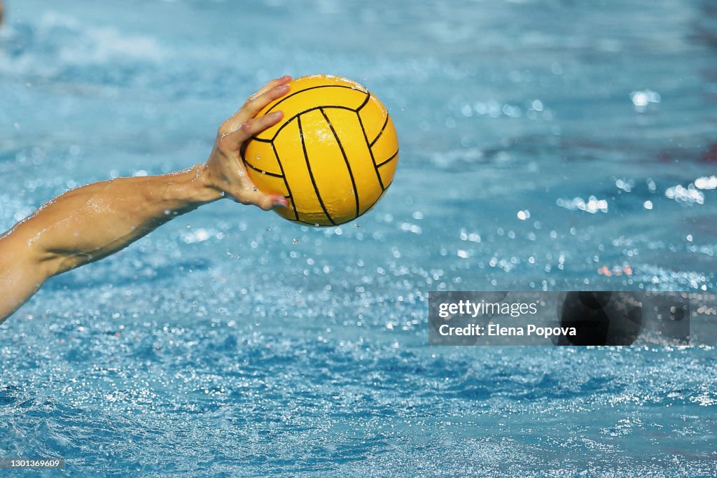 Sportsman Holding a Water Polo Ball above the water
