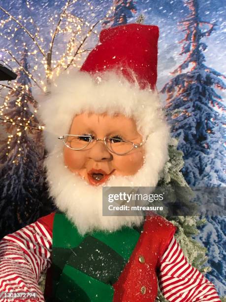 image of toy santa claus figure with fake christmas trees - bushy stock pictures, royalty-free photos & images