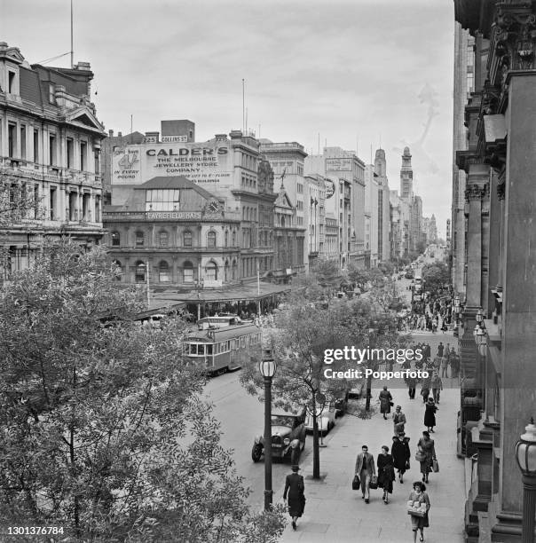 View of pedestrians, trams and cars traversing Collins Street in the centre of the city of Melbourne in Victoria, Australia in October 1948.