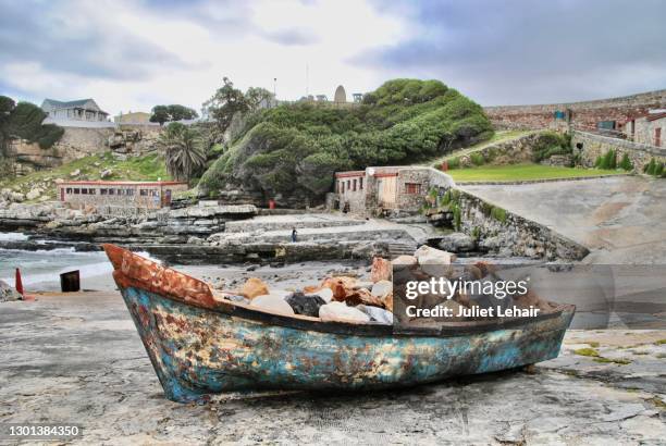 boat of rocks:hermanus harbour. - hermanus bildbanksfoton och bilder