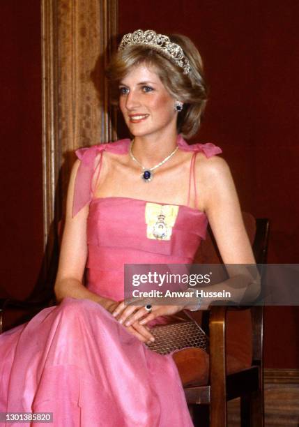 Diana, Princess of Wales, wearing a pink dress designed by Victor Edelstein, the Spencer tiara and the Royal family order of the Queen and Saudi...