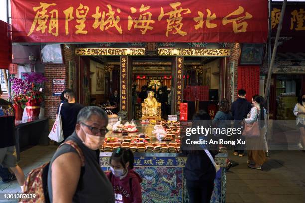 Visitors make offerings at a temple on February 10, 2021 as people prepare for Chinese New Year at Dihua Street in Taipei, Taiwan. Ethnic Chinese...