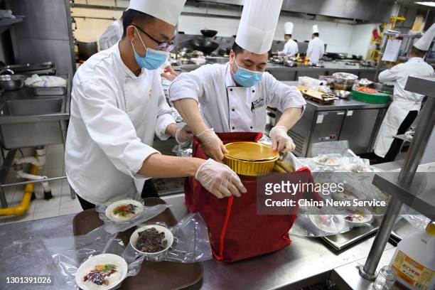 Chefs pack take-out New Year's Eve dinner for customers at a restaurant on February 10, 2021 in Hohhot, Inner Mongolia Autonomous Region of China.