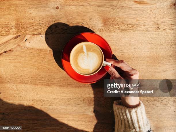 woman drinking coffee at the cafe, personal perspective view - enjoying coffee cafe morning light stock-fotos und bilder