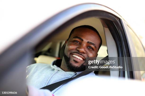 homme de sourire conduisant une voiture - black car photos et images de collection