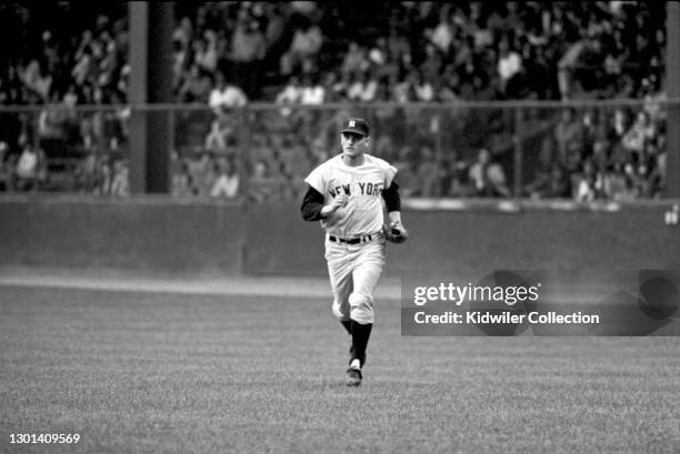 Outfielder Roger Maris of the New York Yankees jogs towards the dugout from the outfield during the first game of a doubleheader against the Detroit...