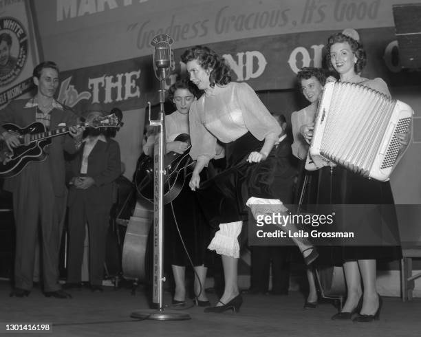 Country singer songwriter June Carter Cash flatfooting on stage with The Carter Family as well as Chet Atkins at the Grand Ole Opry in 1951 in...