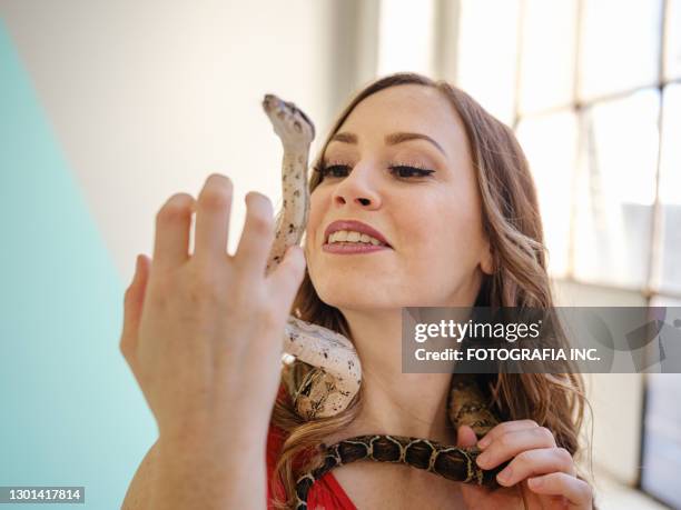 female acrobat with pet snake - pet snake stock pictures, royalty-free photos & images