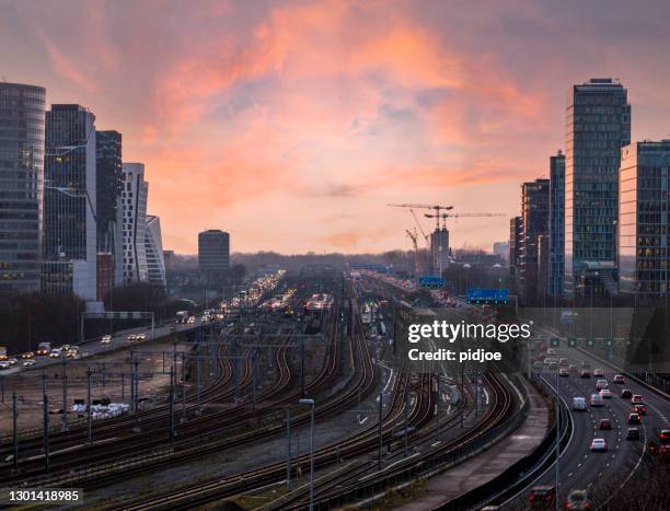 freeway through the zuid-as amsterdam business district - amsterdam zuidas stock pictures, royalty-free photos & images