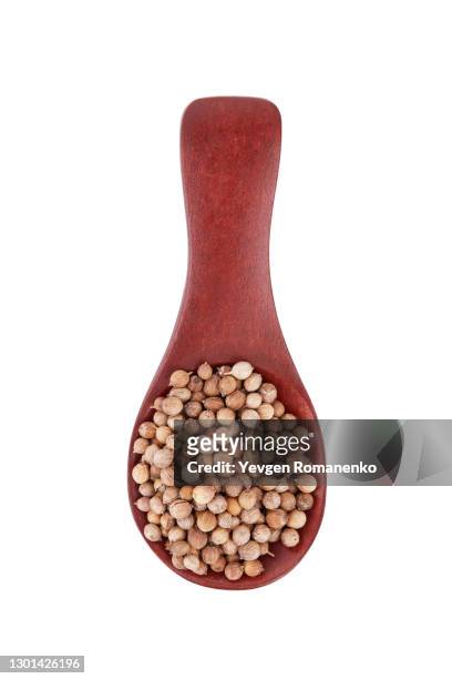 wooden spoon with coriander seeds isolated on white background - coriander seed stock pictures, royalty-free photos & images