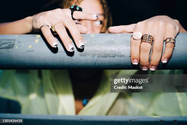 male hipster's hand on fence at night - nagelkunst stockfoto's en -beelden