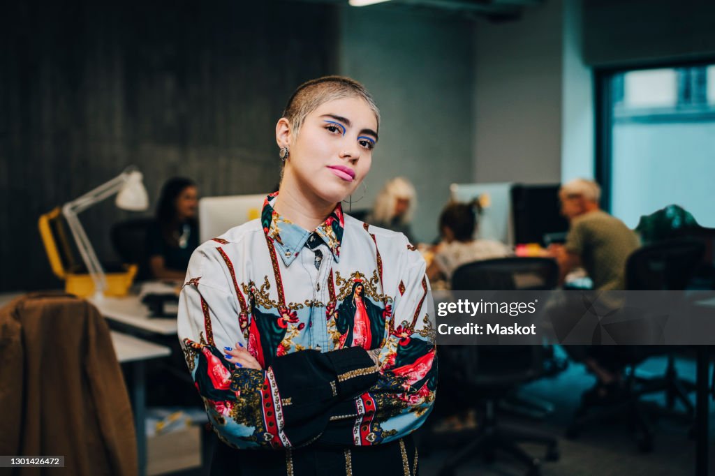 Portrait of businesswoman with arms crossed in IT company