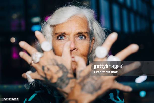 portrait of senior woman showing rings - old woman tattoos stock pictures, royalty-free photos & images
