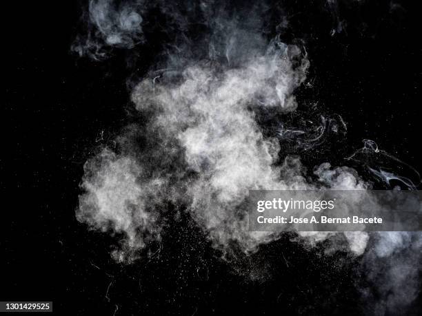 impact explosion of white smoke particles on a black background. - shooting a weapon stock pictures, royalty-free photos & images