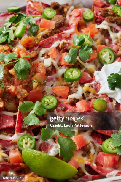 beet and corn tortilla nachos with spicy ground beef - mexican food stock pictures, royalty-free photos & images