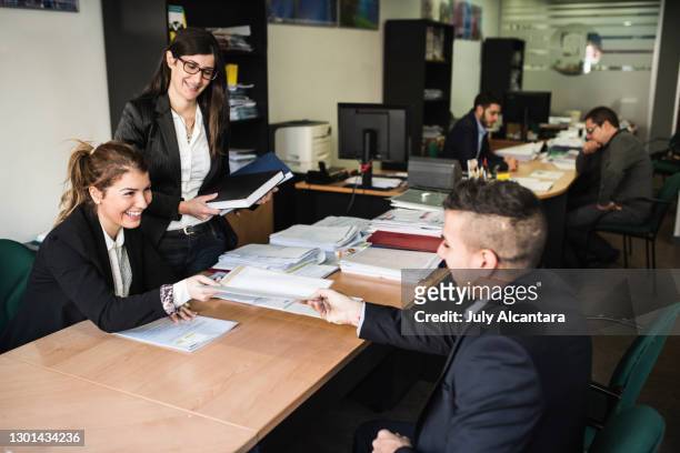 people working in office in insurance company - bank office clerks stock pictures, royalty-free photos & images